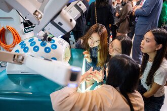 Guests learning about the endoscopic robotic surgical system which is solely created by CUHK. 